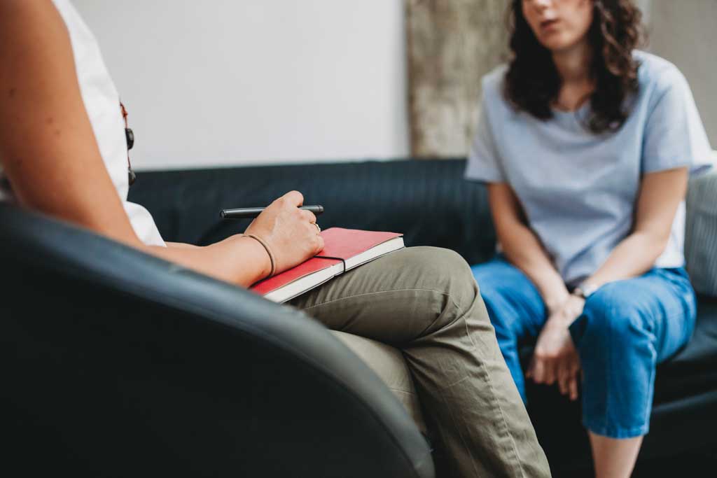 Young woman with coach during ADHD coaching and therapy session