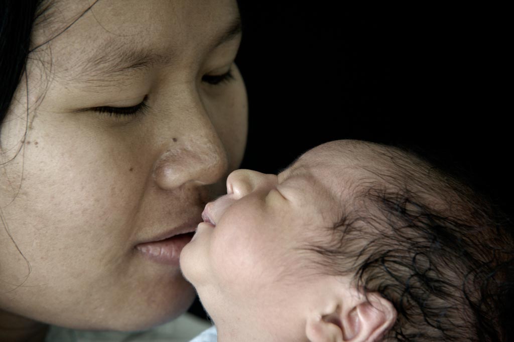 Mother bonding closely with her newborn baby during the postpartum period
